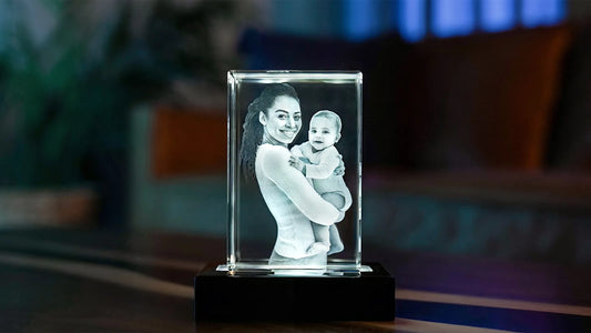 Rectangular 3D crystal engraving of a smiling mother holding her baby, elegantly displayed on a black lighted base.