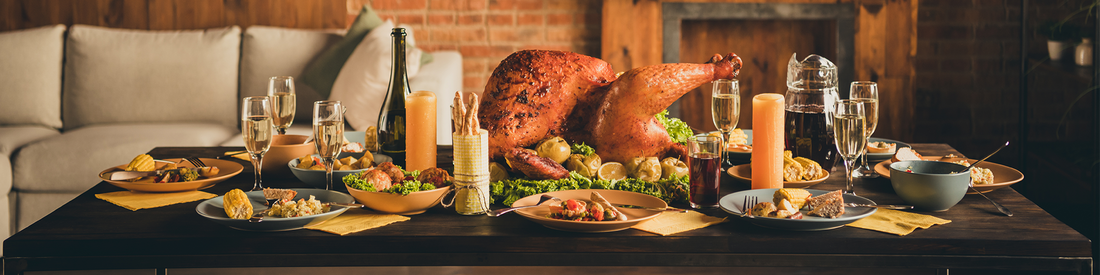 An elegant Thanksgiving table setting with warm autumnal decor, featuring candles and seasonal elements.