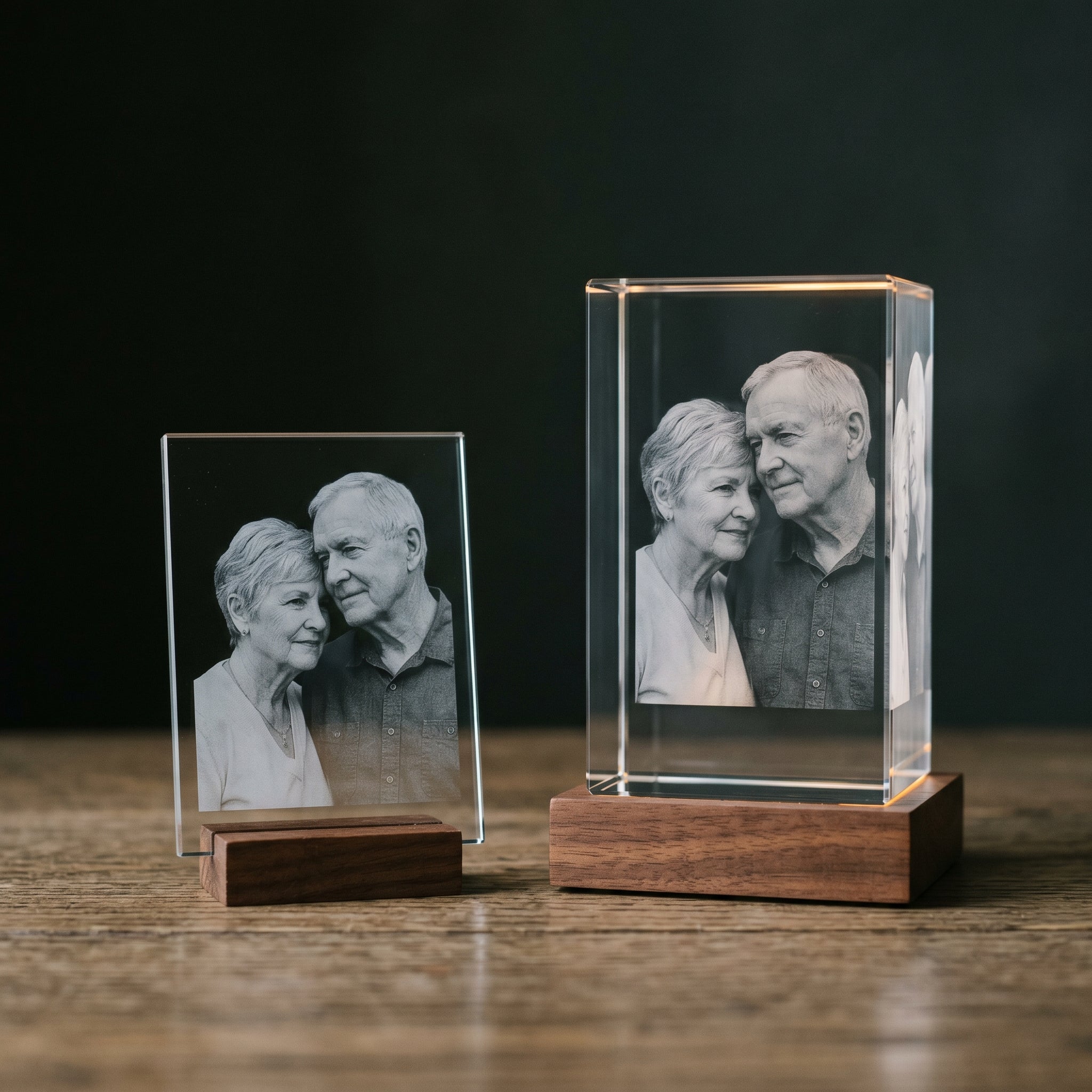 BM 2D flat plate crystal vs 3D thick rectangle crystal side-by-side comparison, both with engraved older couple, walnut bases, dark studio editorial split shot