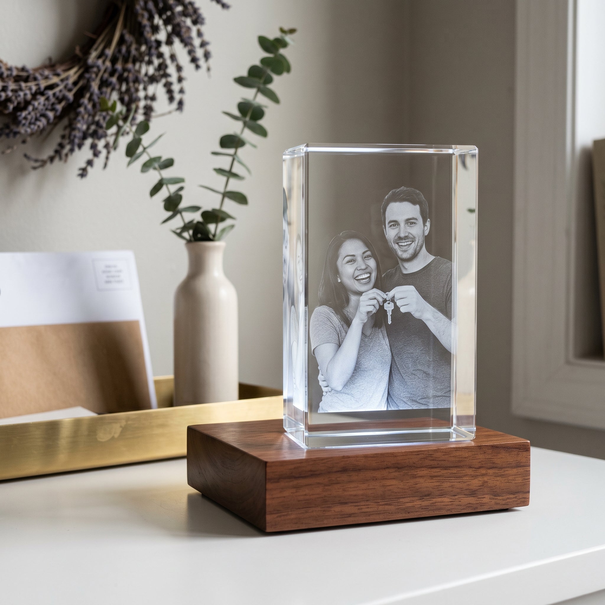 Beyond Memories Rectangle 3D Memory Crystal of mixed-race new homeowner couple on rosewood Light Base, entryway console with brass tray and eucalyptus - useful housewarming gifts.